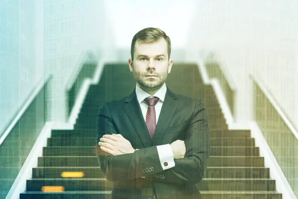 Confident businessman on staircase front toned — Stock Photo, Image