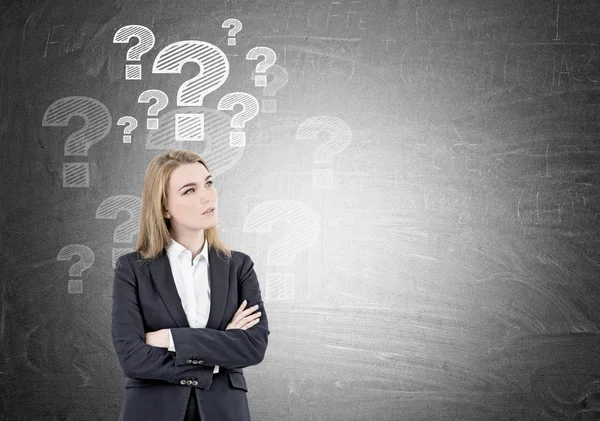 Blond woman and blackboard question marks — Stock Photo, Image