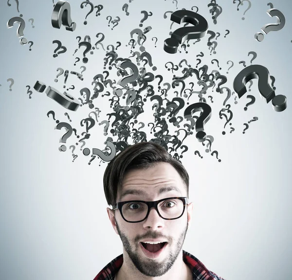 Surprised man in glasses head and question storm — Stock Photo, Image