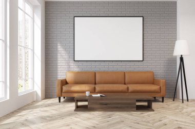 Bir bej kanepe, poster, lamba ile gri oturma odası