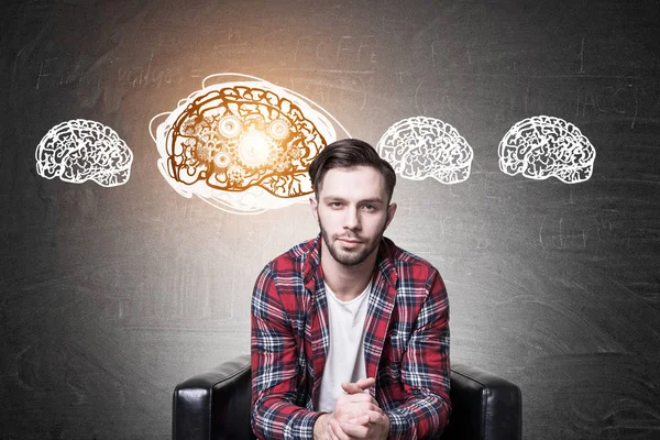 Hipster gars dans un fauteuil et quatre rouages du cerveau — Photo