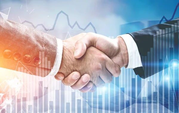 Two businessmen shaking hands, graphs — Stock Photo, Image