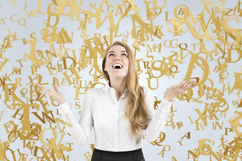 Blond businesswoman crying with joy, letters