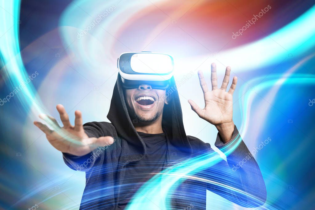 Smiling African guy in VR glasses, abstract