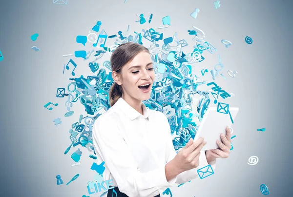 Happy blond woman with tablet, social media icons — Stock Photo, Image