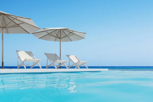 Swimming pool with three deck chairs, umbrellas