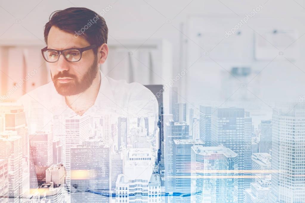 Serious businessman in glasses a city office