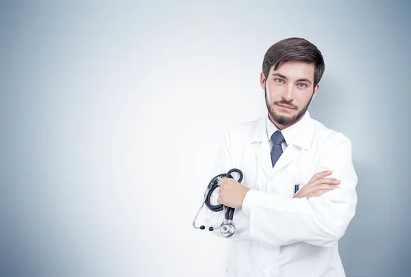 Freundlicher bärtiger Arzt, graue Wand — Stockfoto