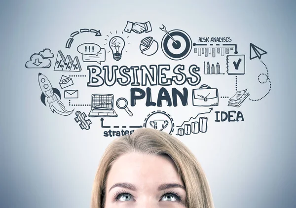 Blonde woman s head and a business plan — Stock Photo, Image