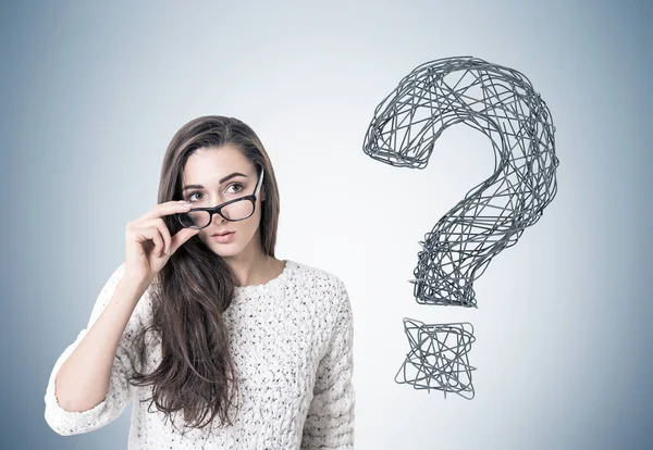 Young woman taking off glasses, question, gray — Stock Photo, Image