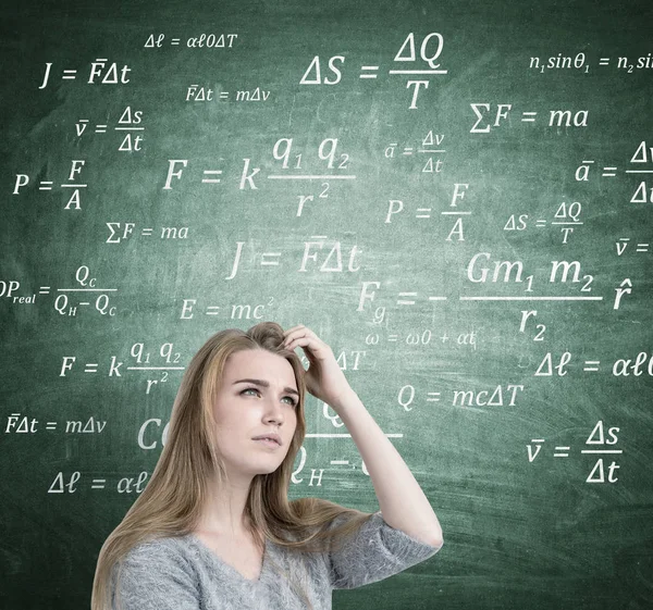 Blonde woman scratching head, formulas Stock Picture