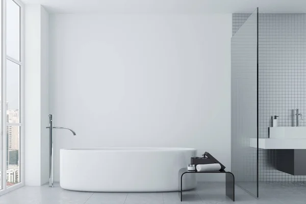 White bathroom, tiles and round tub
