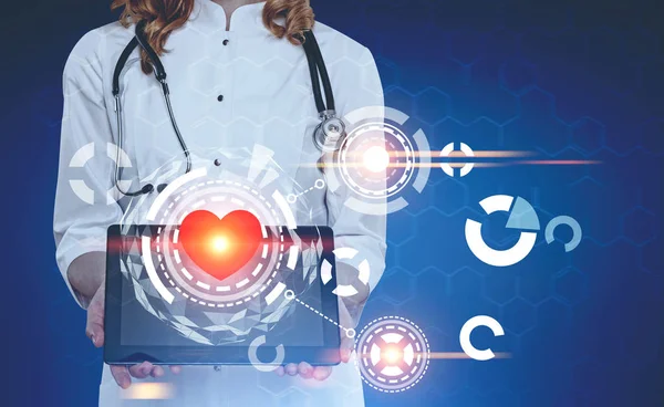 Woman doctor with a tablet and a heart HUD — Stock Photo, Image