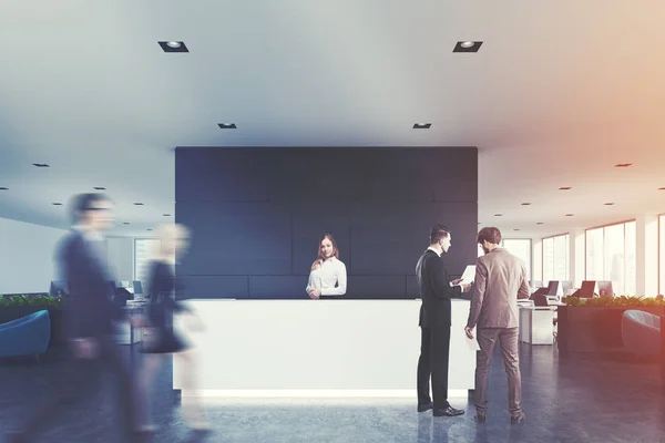 Black wooden office, white reception, people — Stock Photo, Image