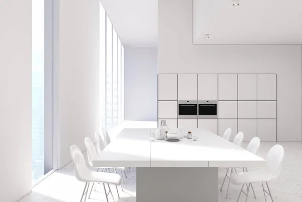 White kitchen with a table, ovens close up — Stock Photo, Image