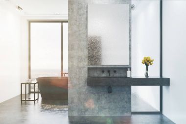 Beton banyo, gri küvet ve tonda lavabo