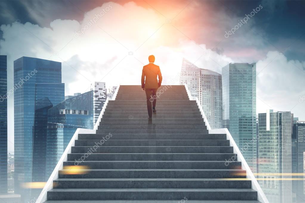 Businessman climbing stairs, city