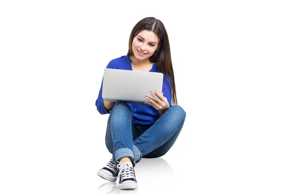 Adolescente chica en jeans y camisa sosteniendo portátil — Foto de Stock