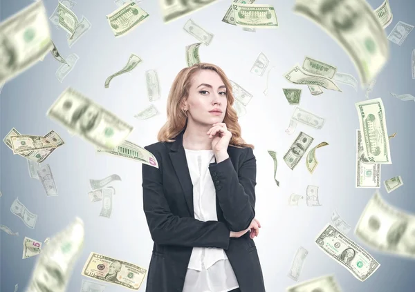 Pensive red haired businesswoman, dollar rain — Stock Photo, Image