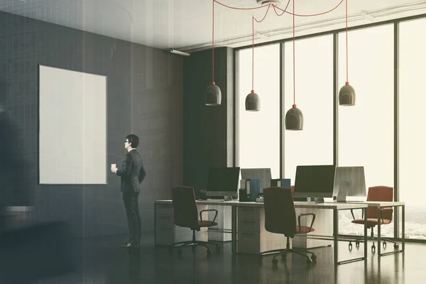 Темно-сірий офісний куточок, червоні стільці, тонований плакат — стокове фото