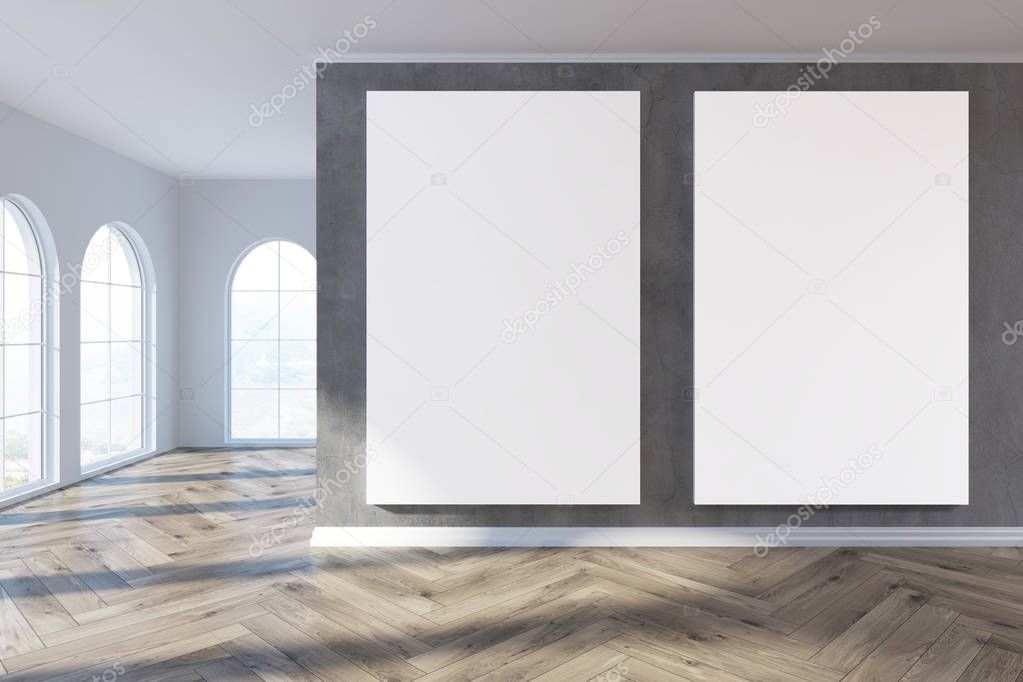 Empty gray room with two posters
