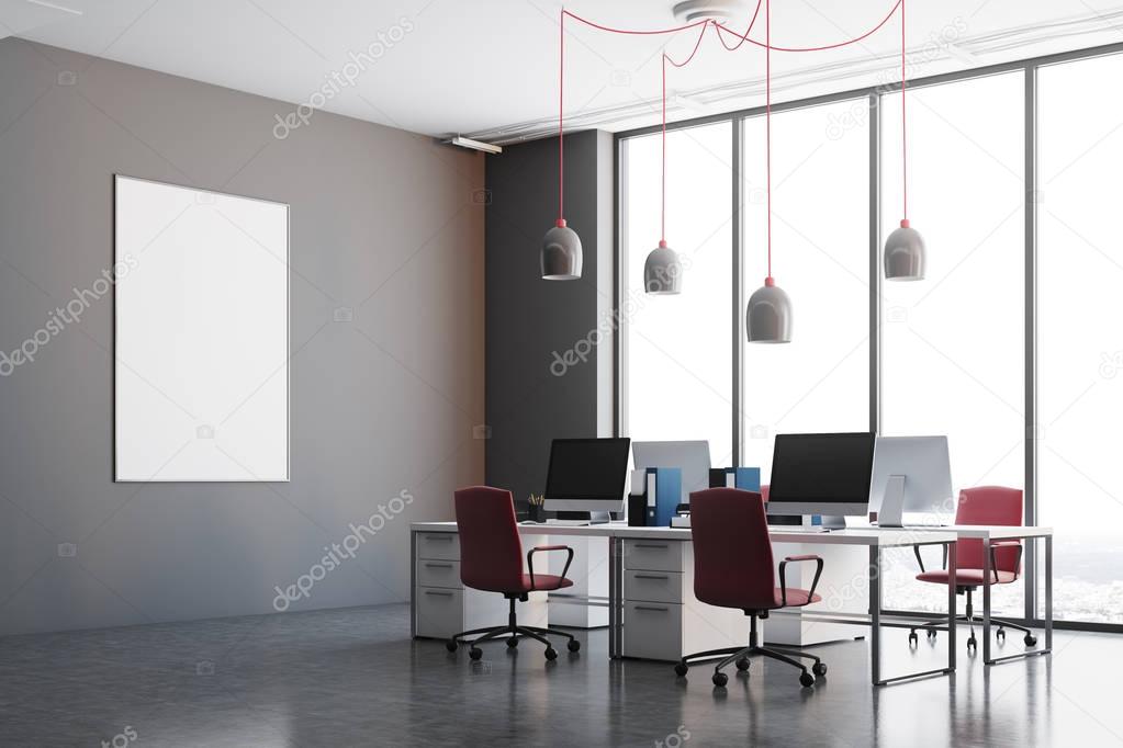 Dark gray office corner, red chairs, poster