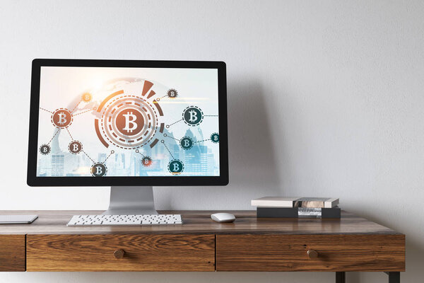 White monitor on wooden table, bitcoin icon