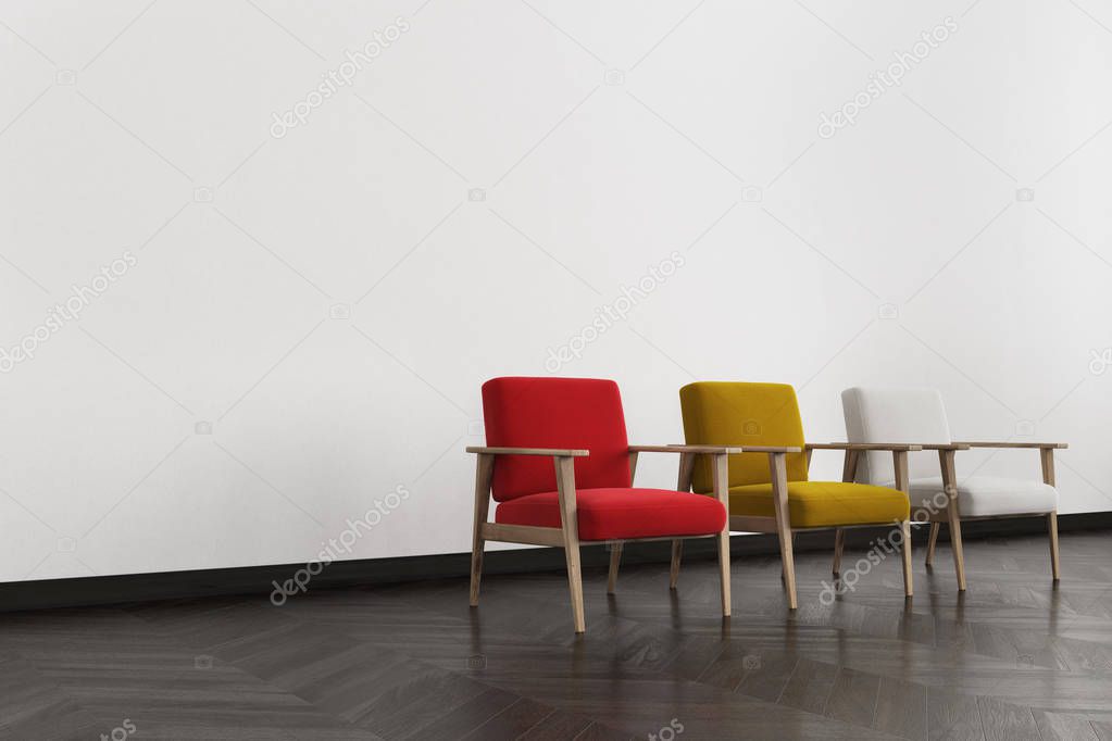 Red, white and yellow armchairs in a room side