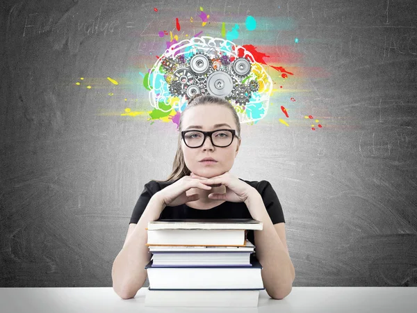 Serious blonde student, books, cog brain — Stock Photo, Image