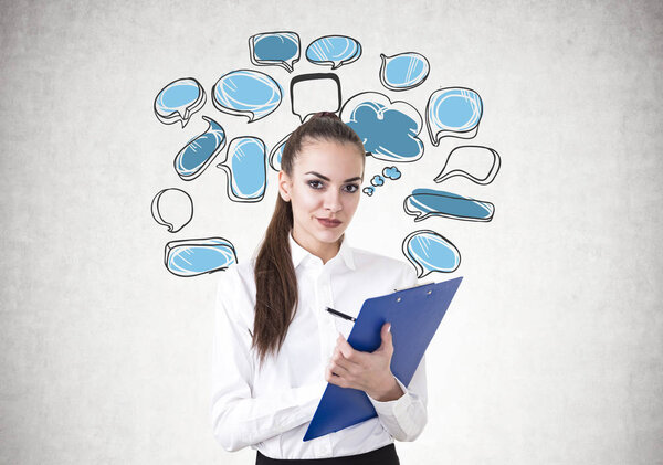 Young businesswoman writing, speech bubbles