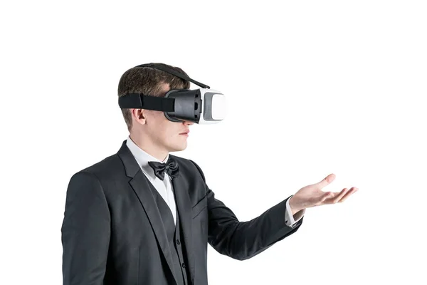 Businessman in VR glasses showing with a hand — Stock Photo, Image