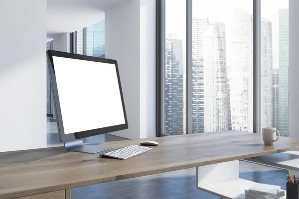 Witte computerscherm op een houten deskside — Stockfoto