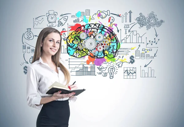 Blonde woman with a planner, brain — Stock Photo, Image