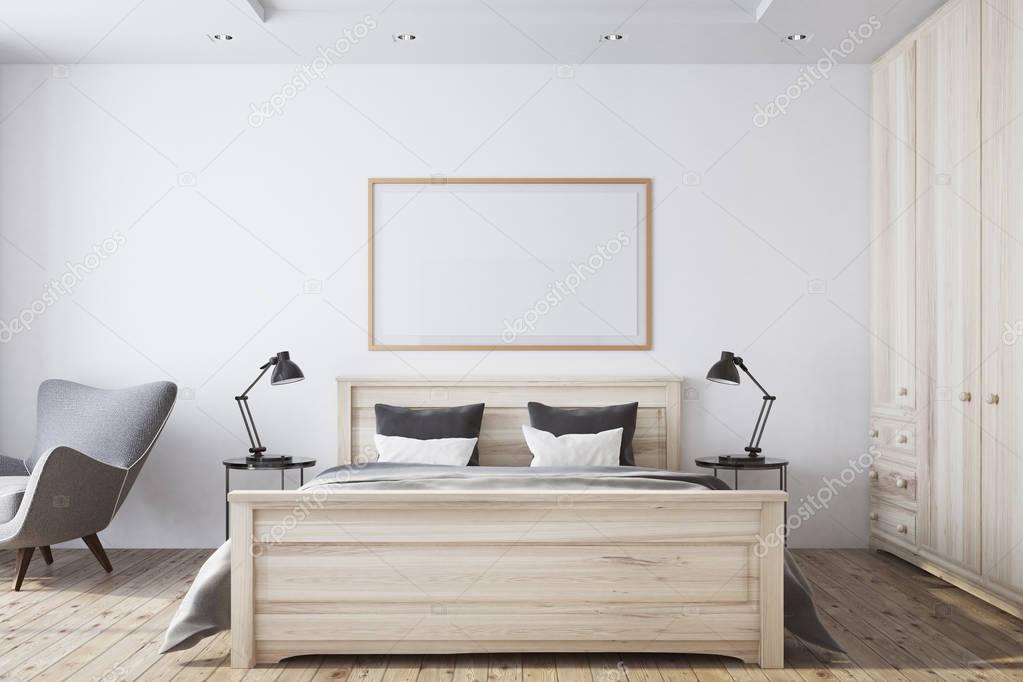 White bedroom interior with framed poster