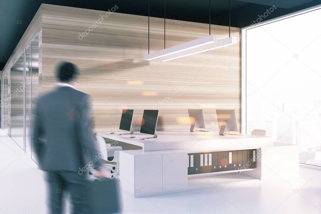 Black ceiling office corner, computer screens blur