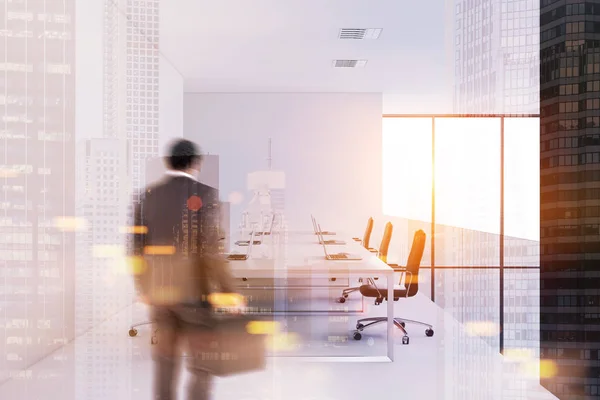 Businessman entering a white wall meeting room — Stock Photo, Image