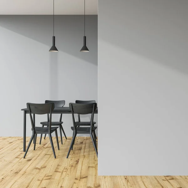 Mesa de comedor gris oscuro en una habitación gris, pared — Foto de Stock