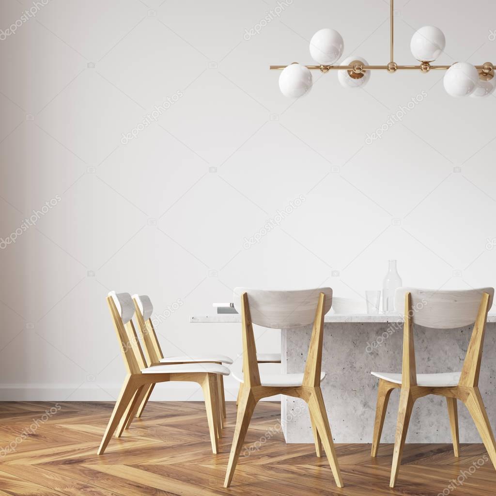 White dining table with design chairs close up