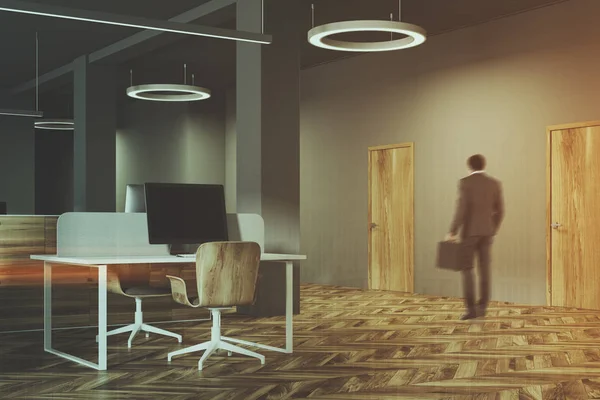 Темный и деревянный офисный интерьер, человек — стоковое фото