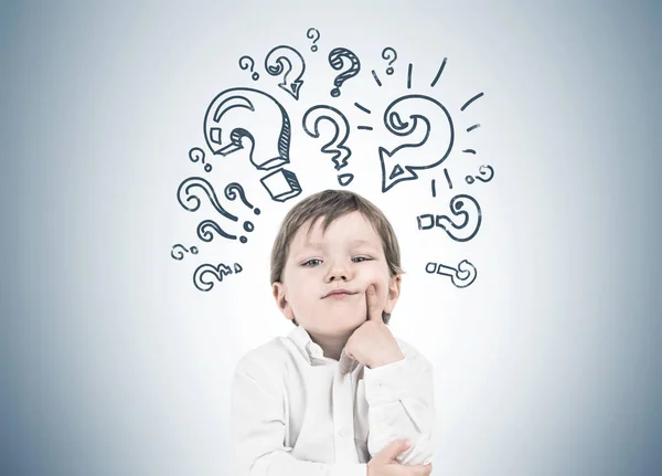 Thinking little boy, finger cheek question marks — Stock Photo, Image