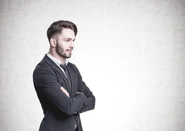 Pensive bearded businessman, side view, concrete — Stock Photo, Image