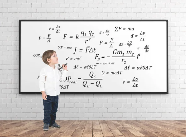 Cute little boy with a marker, formula — Stock Photo, Image