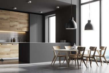 Bir tablo, yan görünümü ile gri ve ahşap mutfak