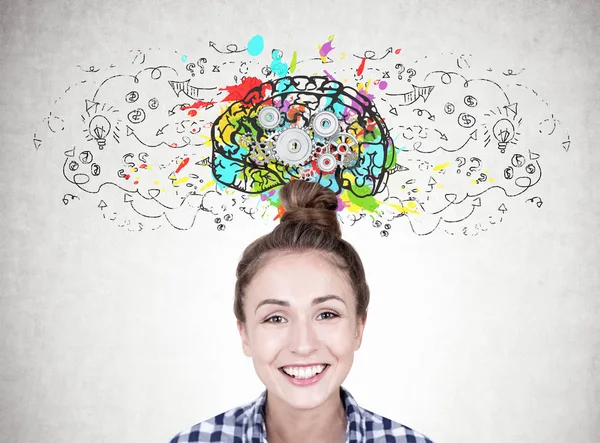 Smiling young woman with a bun, gear brain — Stock Photo, Image