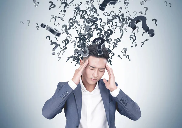Stressed Asian businessman, many questions — Stock Photo, Image