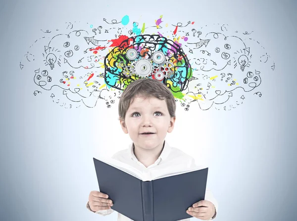 Cute little boy with a book, cog brain — Stock Photo, Image