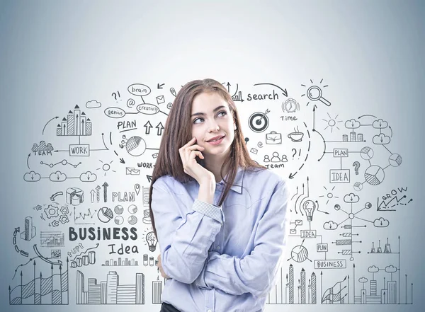 Dreamy young woman in a blue shirt, business plan — Stock Photo, Image