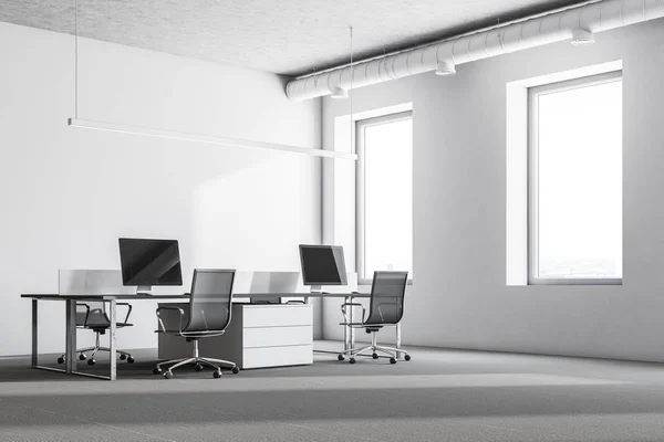 Luxury office interior with white walls, large windows, a concrete floor and rows of computer tables. 3d rendering mock up