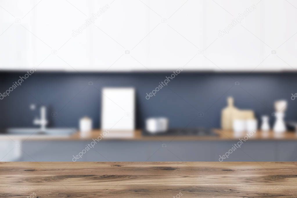 Gray kitchen countertops with built in appliances and a row of white cupboards hanging above them. A framed poster. 3d rendering mock up blurred