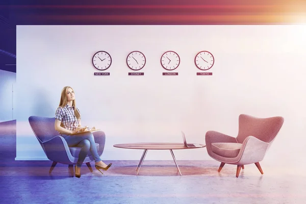 White wall office lobby with clocks, woman